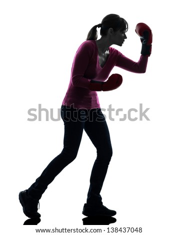 one caucasian woman with boxing gloves  in silhouette studio isolated on white background