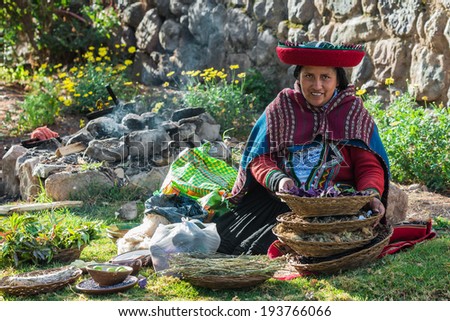 CUZCO, PERU - JULY 15, 2013: woman with natural dyes in the peruvian Andes