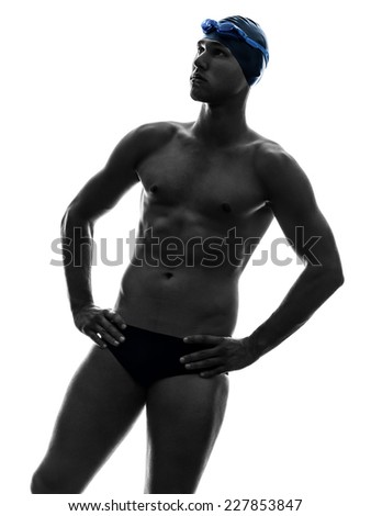 one young man swimmer swimming in silhouette on white background