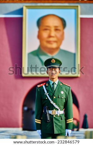 Beijing , China - September 24, 2014: Chinese soldier in front of the soldier in front of mao zedong poster portrait Tiananmen Square forbidden city Beijing China