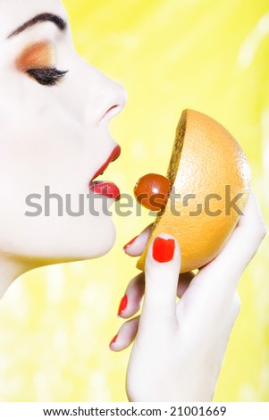 beautiful woman portrait with colorful make-up  and background holding grapefruit