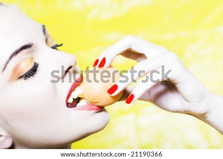 beautiful woman portrait with colorful make-up  and background biting apricot