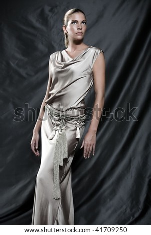 Fashion pictures of a beautiful woman wearing cream satin cocktail dress
