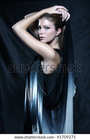 fashion pictures of a beautiful woman wearing silk fringe black and white dress chinese style doing martial arts posture