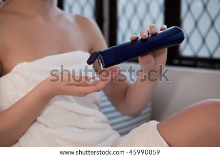 woman relaxing in a spa lounge in india arabic style applying skincare lotion