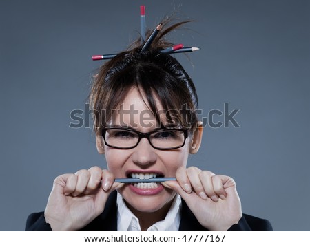 beautiful business woman biting her pencil  on isolated bacground