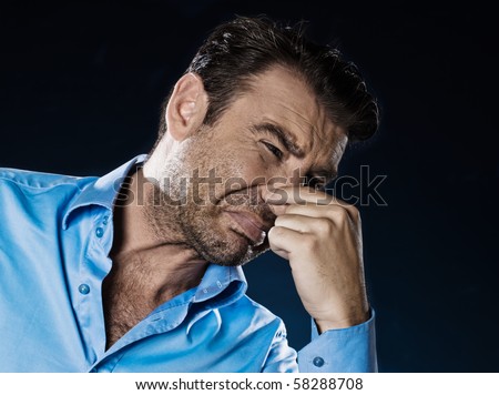 caucasian man unshaven pucker unpleasant smell portrait isolated studio on black background