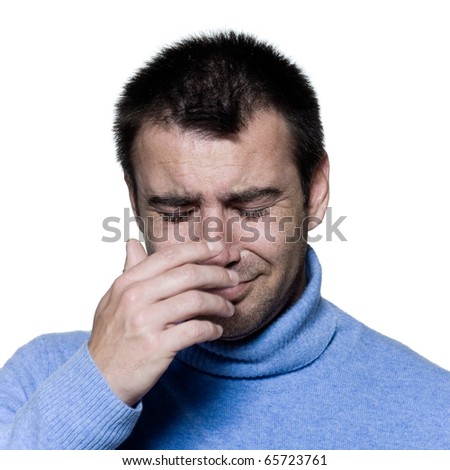 studio portrait on isolated background of a stubble man crying sad depression