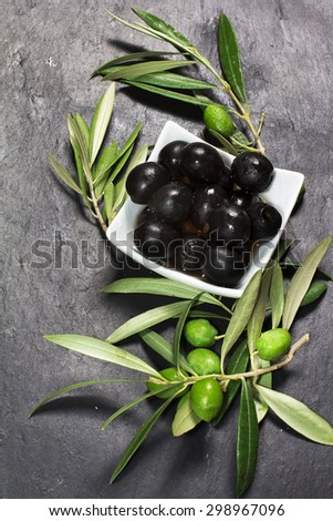 Fresh marinated olives over dark slate