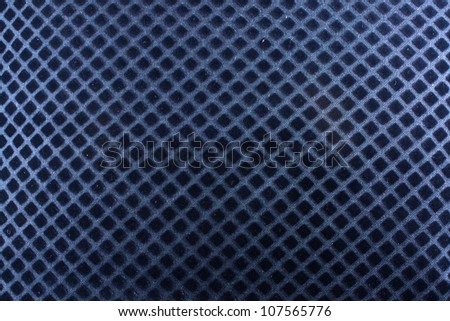 A background of a blue fabric with a pattern of diagonal lines crossing each other.