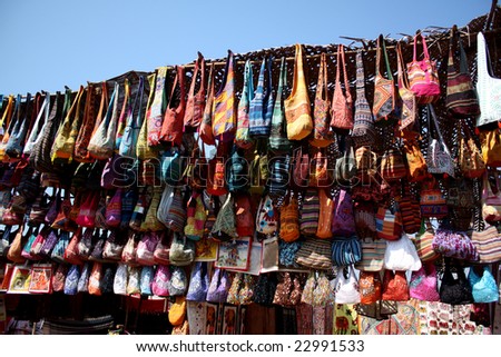A background with a view of a shop in Indian selling ethnic Indian bags.