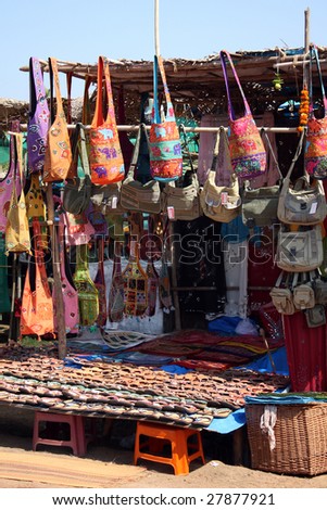 A streetside shop selling different types of bags in a flea market in Goa, India.