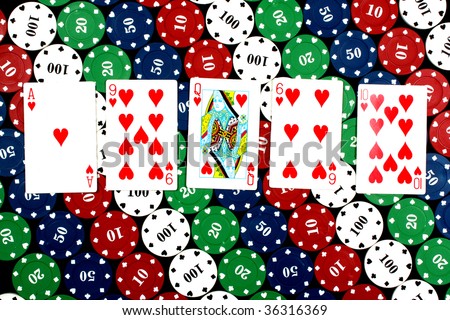 A poker hand of flush consisting of all heart cards, on casino counters background.