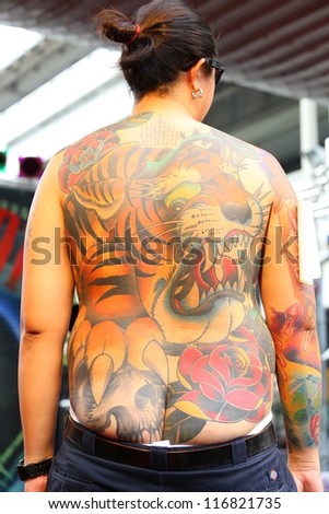 BANGKOK, THAILAND - OCTOBER 23 : Unidentified Thai people show old school tattoos at MBK Center on display \