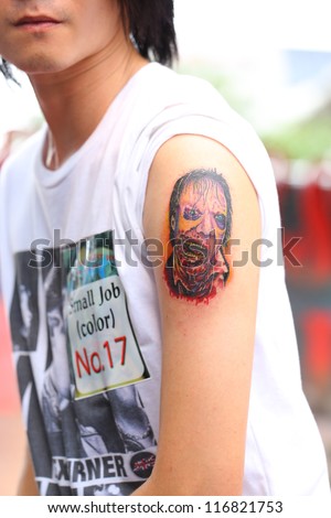 BANGKOK, THAILAND - OCTOBER 23 : Unidentified Thai people show old school tattoos at MBK Center on display 
