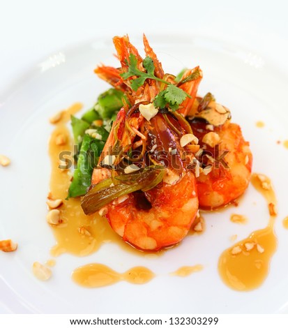Stir shrimp with sweet sauce and vegetables on white plate