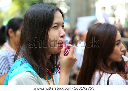 BANGKOK,THAILAND - DECEMBER 20: Employees at Silom neighborhood whistle for anti-government. The protest Against The Amnesty bill in Bangkok, capital of Thailand on 20 December 2013