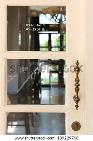 Transparent door of vintage restaurant open daily 10.00 - 23.00 Hrs.