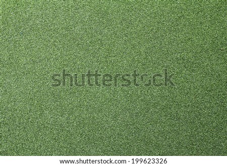 Artificial grass wall. Artificial turf. Thin green plastic.