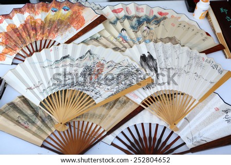 BANGKOK, THAILNAD - FEBRUARY 14: Painted on Chinese paper fan on sale at Central World Plaza during the Chinese New Year celebrations on February 14, 2015 in Bangkok, Thailand