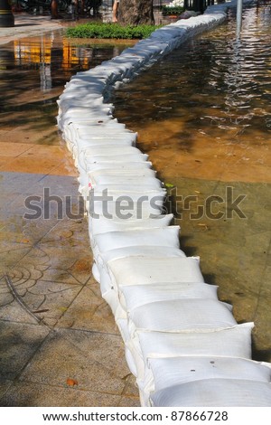 BANGKOK, THAILAND - OCTOBER 29 : Sandbags are placed to prevent flooding after Water burst its banks on the Chao Phraya River on October 29, 2010 in Bangkok, Thailand.