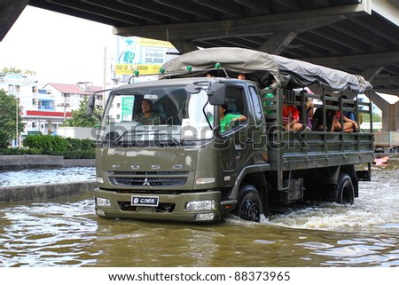 BANGKOK THAILAND - NOVEMBER 8 : Unidentified people sit in big truck to escape rising flood waters at Vipavadeerangsit Road suthisan junction, in Bangkok, Thailand on Nov. 8, 2011.