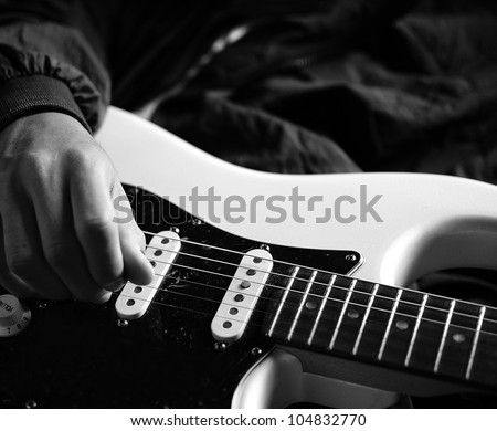 man playing electrical guitar