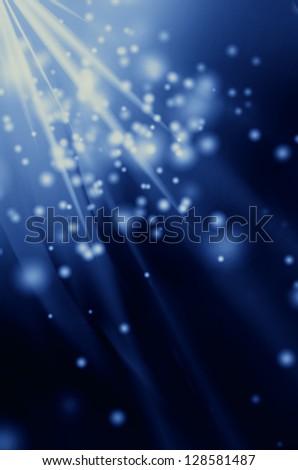 snowflakes and stars descending on a path of blue light