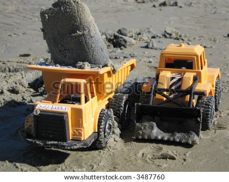 Toy trucks that have been working in the sand