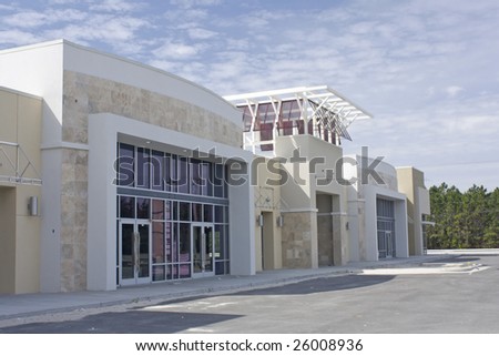 beige, brown and white strip mall with stone accents