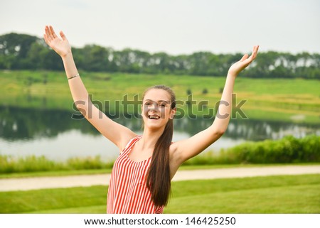 Healthy and happy woman holding up arms for winning, success, excitement, and joy