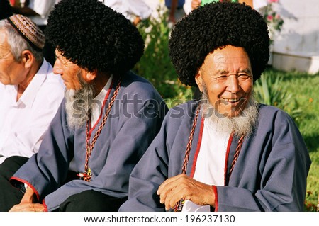 Ashgabat, Turkmenistan - August 26.  Portrait of two old unidentified Laughing Asian men. Oriental bazaar. Ashgabat, Turkmenistan - August 26. 2013.