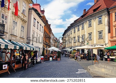 LJUBLJANA, SLOVENIA -  JUNE 28, 2014: Street in the old city center of Ljubljana with street shops and cafes. LJUBLJANA, JUNE 28, 2014.