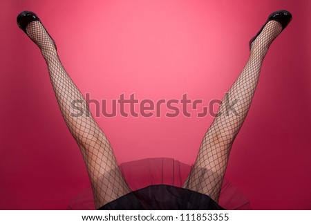 Sexy woman legs open wide on red background