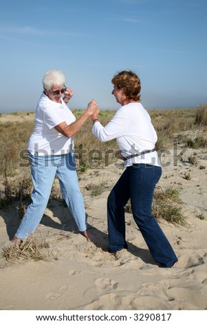 Mother and daugher in a boxing match on the oceanfront