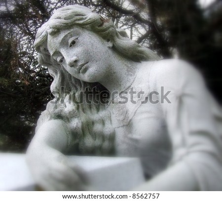 old statue depicting woman mourning a death