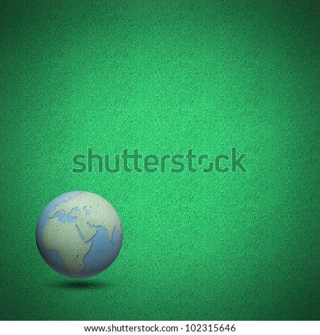 Globes by cork board on green grass