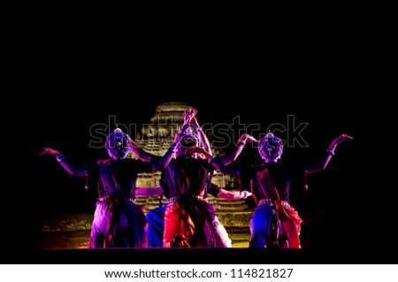 KONARK, INDIA - SEPTEMBER 24: An unidentified group of lady dancers wear traditional costume and perform Odissi dance at Konark temple on September 24, 2012 in Konark, Orissa, India