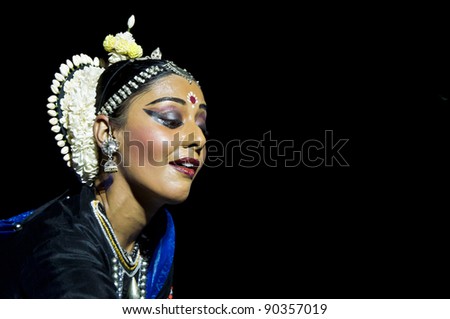 KONARK, INDIA - DECEMBER 04: An unidentified lady dancer wears traditional costume and performs Odissi dance at Konark temple on December 04, 2011 in Konark, Orissa, India