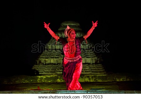 KONARK, INDIA - DECEMBER 04: An unidentified lady dancer wears traditional costume and performs Odissi dance at Konark temple on December 04, 2011 in Konark, Orissa, India