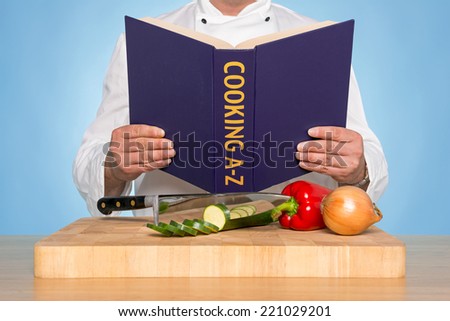A chef reading a COOKING A-Z book