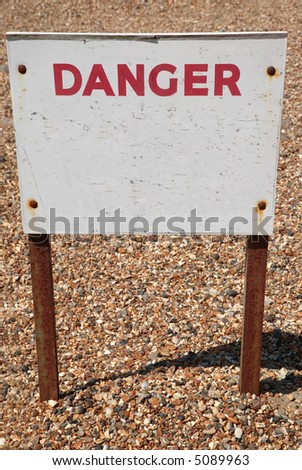 Old weathered sign with the word Danger, the rest is blank for your own text.