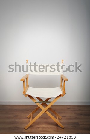 One chair on a wooden floor illuminated with a single light source