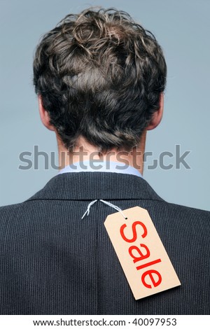 Rear view of a male wearing a suit jacket with a Sale label on it.