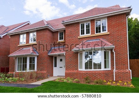 Photo of a brand new unoccupied detached red brick built five bedroom house on a modern housing development.