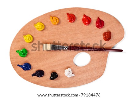 Photo of a wooden artists palette loaded with various colour paints and brush, isolated on a white background with clipping path.