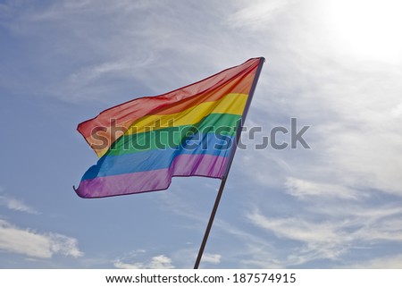 Gay Pride flag shining on the sky