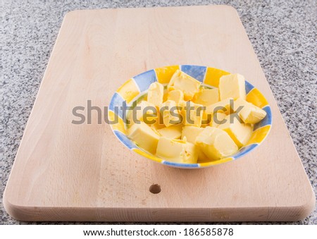 A group of melting butter on a kitchen pastry board.