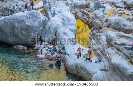 VERZASCA RIVER, SWITZERLAND - SEPTEMBER 15TH, 2012. Scuba diving in Verzasca river, Switzerland. The river is a popular location among divers for its clear turquoise water and vibrant colored rocks.