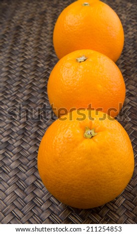 Orange fruits over wicker background